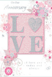 In this image, an anniversary card lies poised like a gentle promise, its palette of soft pastel pinks and silvery greys creating a cocoon of calm romance that would suit a cosy White City flat. The centrepiece is the word LOVE, crafted in raised, velvety glitter that feels slightly textured beneath the fingertips. The glitter is subtle yet luminous, and the letterforms are rounded and inviting, conveying warmth through touch as much as through sight. The O in LOVE is interpreted as a tender heart shape, shimmering in a denser silver texture that makes it stand out like a cherished keepsake among treasured photographs on a mantelpiece. Framing this focal point, delicate floral illustrations in blush, mauve, and soft ivory unfurl across the card, their petals washed with a watercolour softness. The flowers are linked by slender, flowing stems and vines, which curl and sweep in arcs that echo the natural curves of stems in a freshly arranged anniversary bouquet from a local White City florist. Scattered among the petals are tiny flourishes: small swirls, gently drifting petals, and the faint suggestion of butterflies, adding a sense of light movement as if a breeze were passing across the design. The background combines pale pink tones with hints of silvery grey, bathing the card in an atmosphere of treasured intimacy and shared history. Elegant script phrases-On Our Anniversary and I love you today and always-are arranged thoughtfully within the composition, their graceful strokes mirroring the curves of the vines. The card feels softly spoken yet profoundly heartfelt, a quiet tribute to enduring love and all the moments that have led to this anniversary.